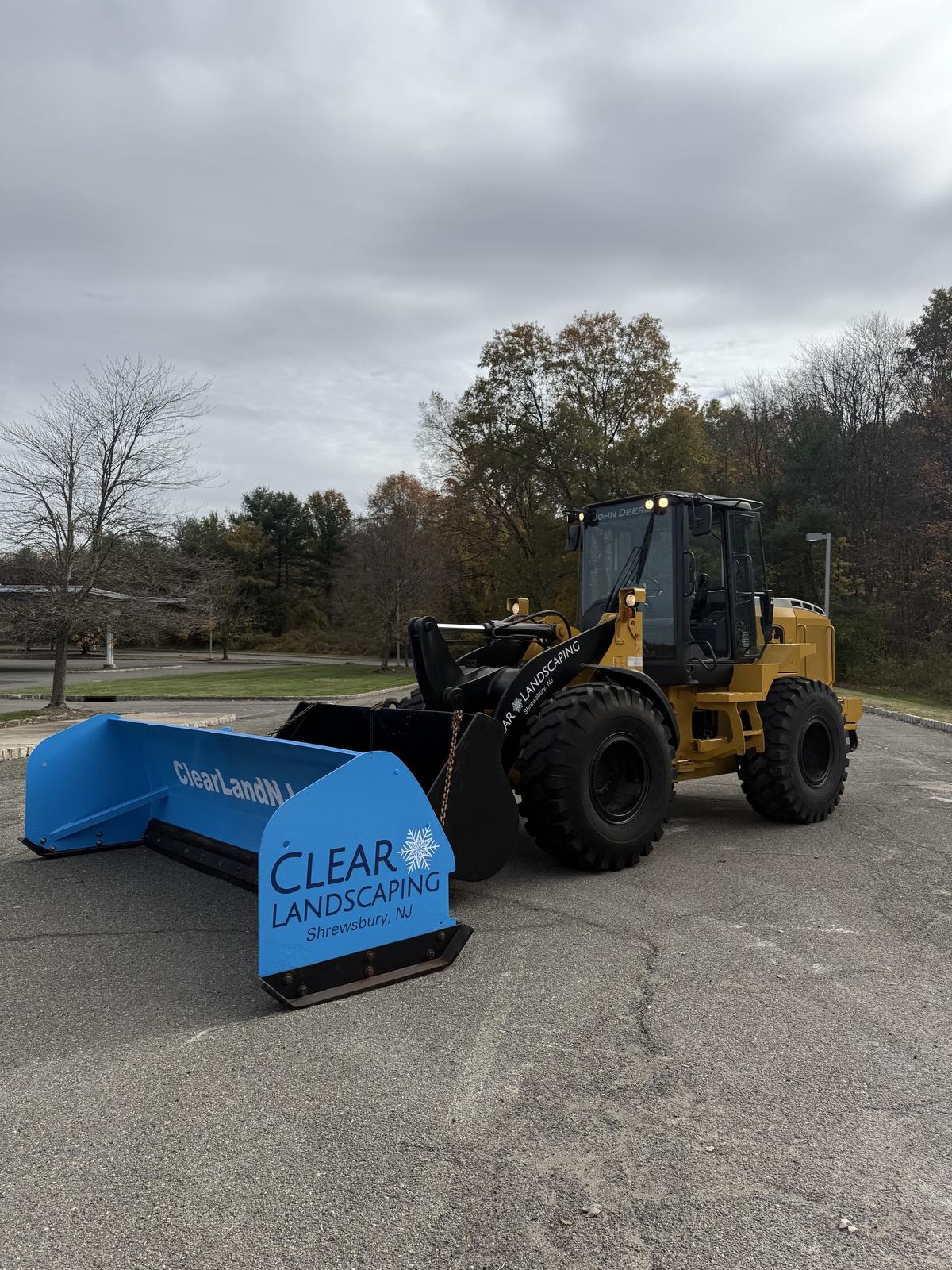 Full-size wheel loader fitted with a Clear Landscaping box pusher