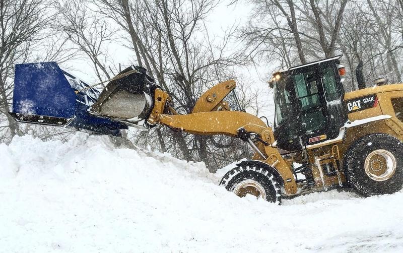 Loader with a Clear Landscaping box pusher clearing a commercial lot