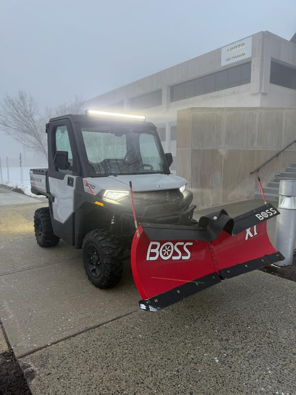 Sidewalk machine working through a whiteout